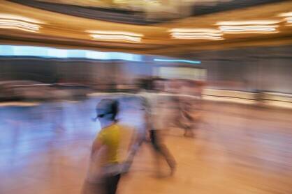 A blurred image of people moving