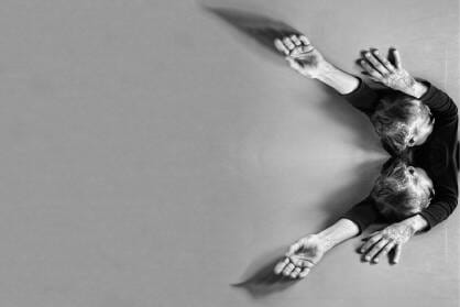 A body is mirrored in black and white