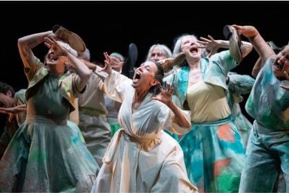 A group of older women writhe on stage as if screaming